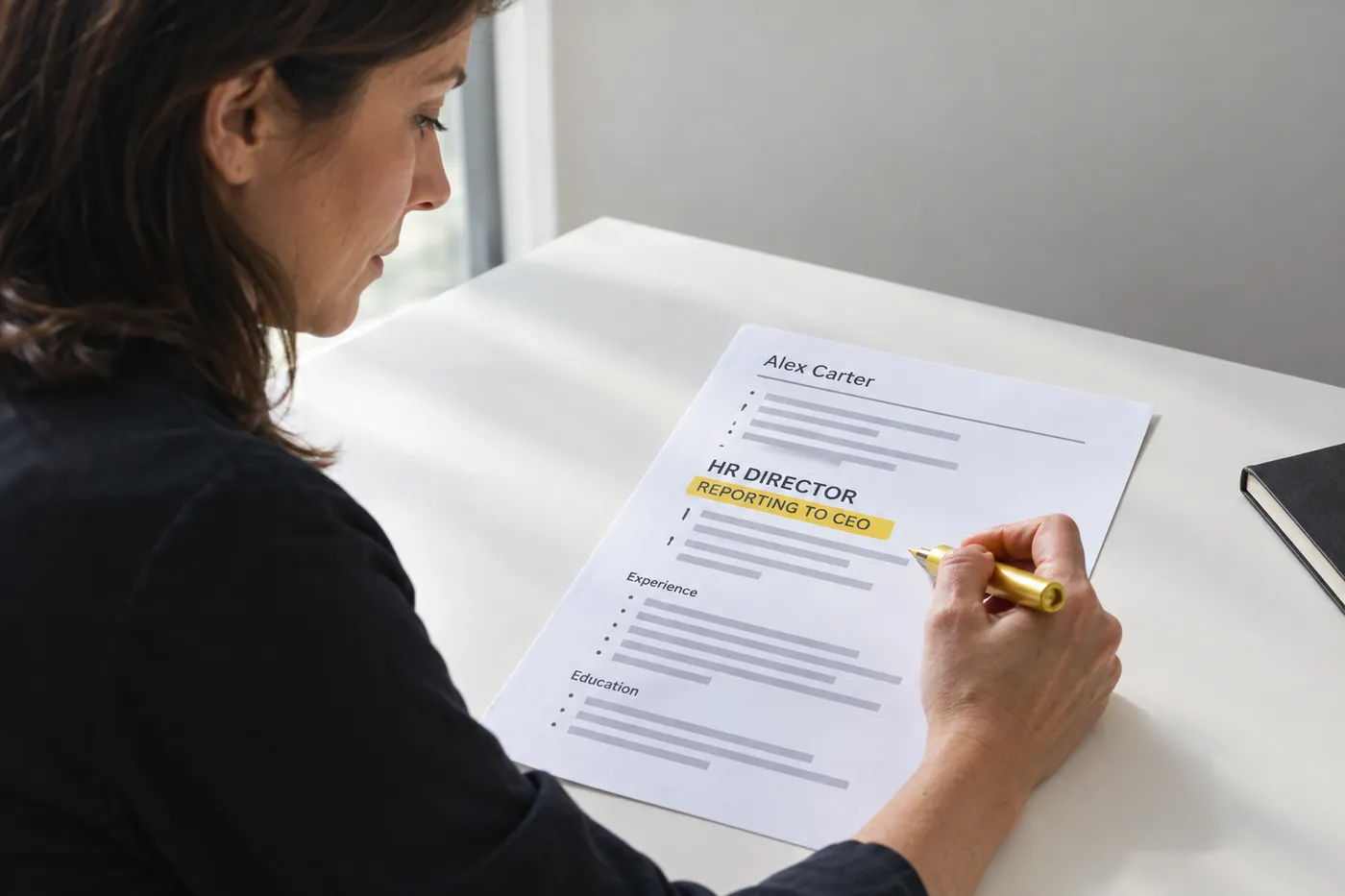 A printed HR director resume with the line Reporting to CEO highlighted, for an article on executive reporting structures.