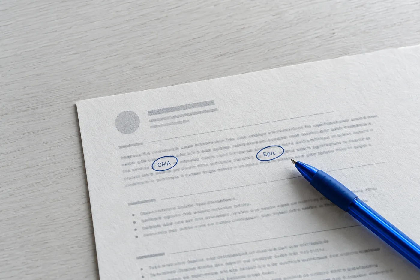 A close-up of a healthcare resume summary with the certification and EMR system circled in blue ink.