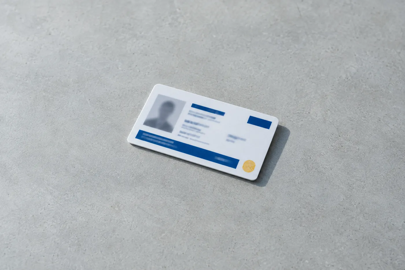 A professional pharmacy technician certification card with blue markings on a clean grey surface.